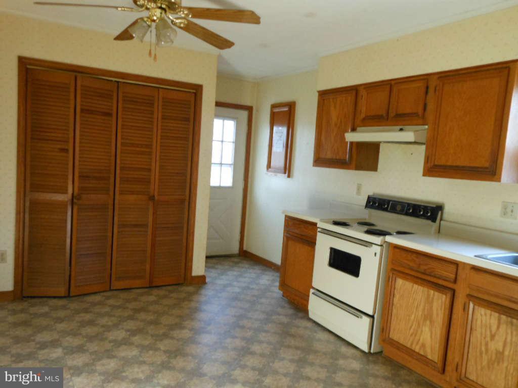 15140 Sheads Mountain Road Rixeyville, VA 22737 - Photo 7 of 12 an white stove top oven sitting inside of a kitchen