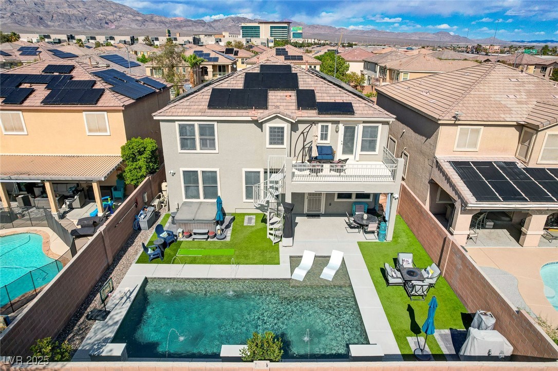 Rear view of house with a fenced backyard, a resid