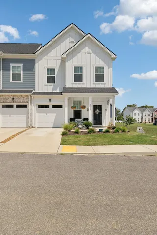 a view of a house with swimming pool and a yard