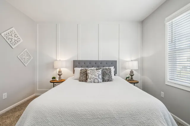 a bedroom with a bed and window