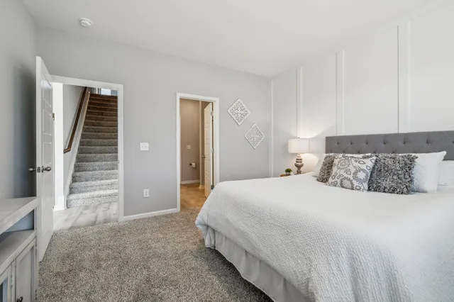 a bedroom with a bed and a large mirror