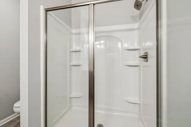 a bathroom with a glass shower door