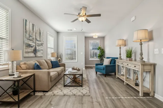 a living room with furniture and a chandelier