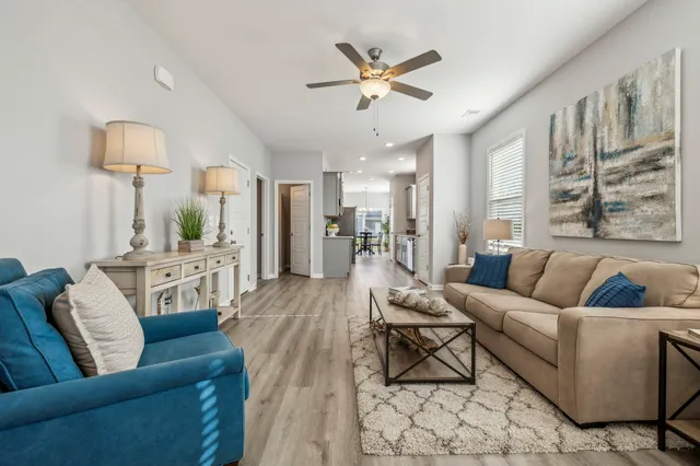 a living room with furniture and a wooden floor