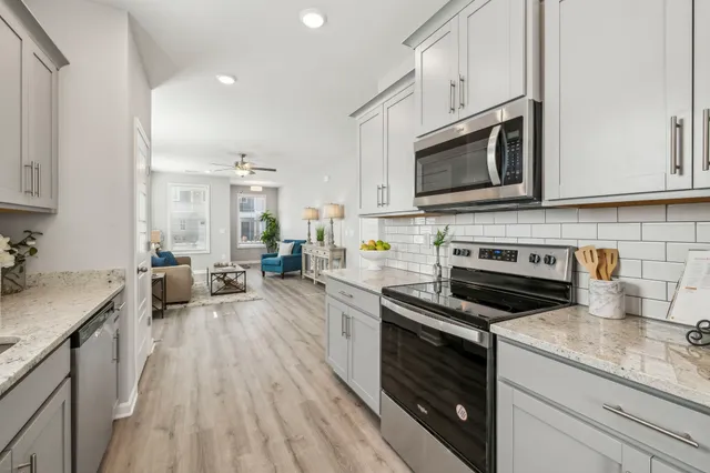 a kitchen with sink a stove and cabinets