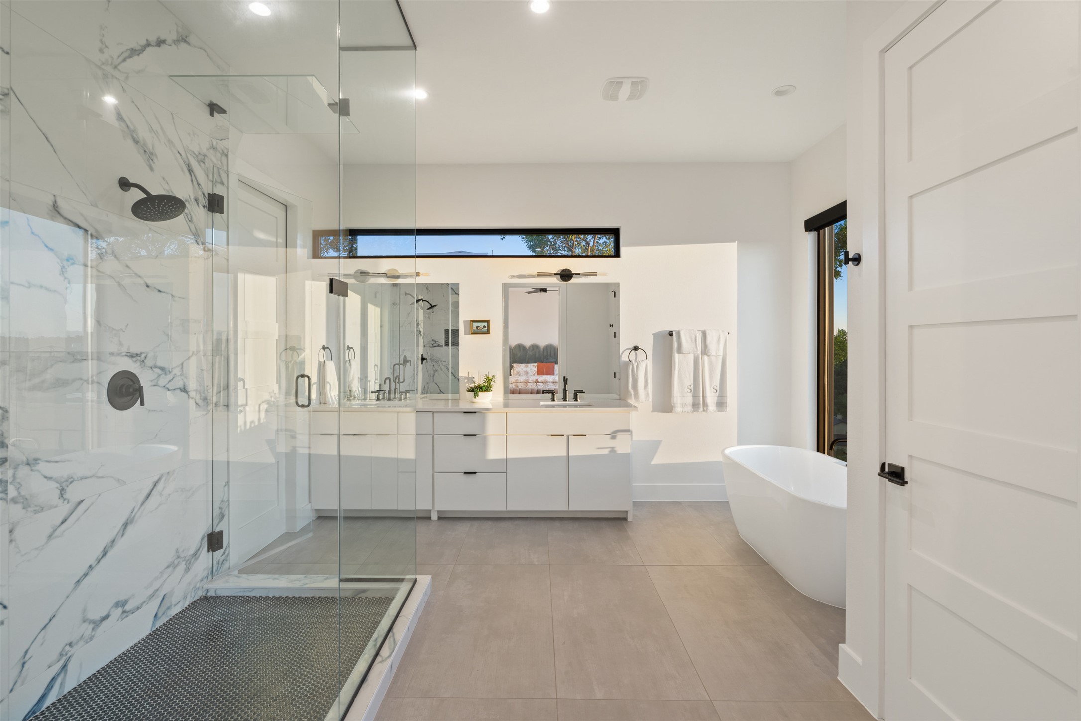 14417 Cochise Trail Austin, TX 78734 - Photo 22 of 40 a bathroom with a tub a window and a shower