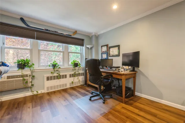 a view of workspace with wooden floor and windows