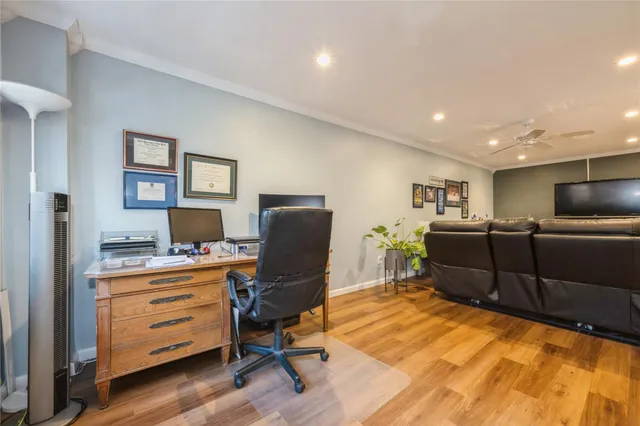 a view of a workspace with furniture and a window