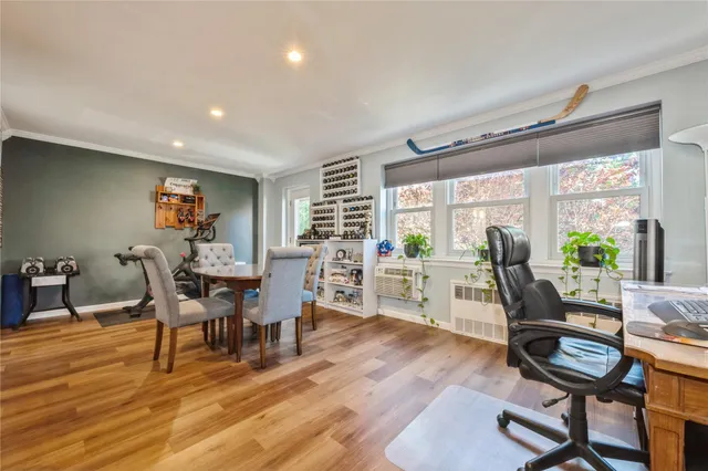 a dining room with furniture and wooden floor