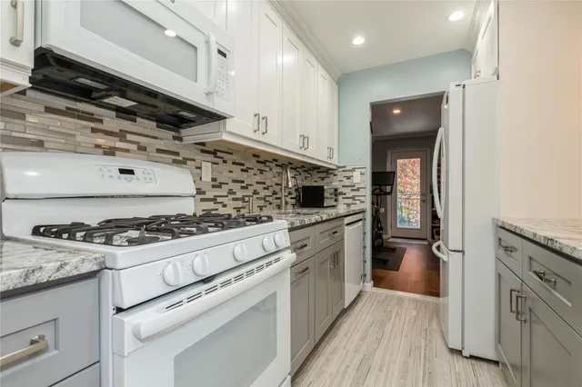 a kitchen with granite countertop a stove and a sink