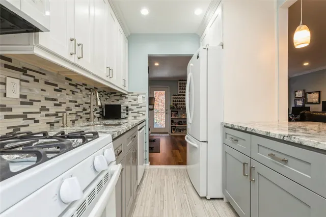 a kitchen with a stove and a refrigerator