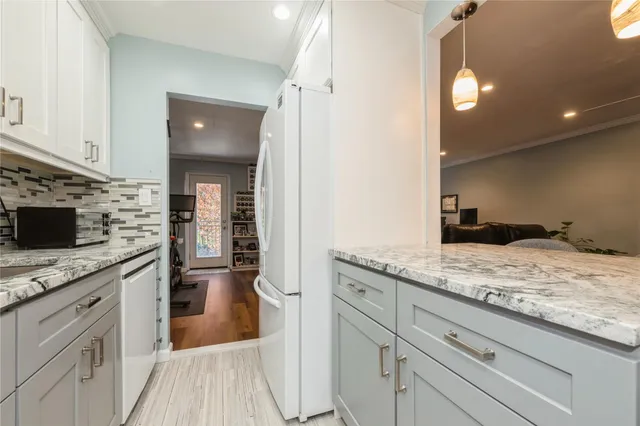 a bedroom with a bed and large windows