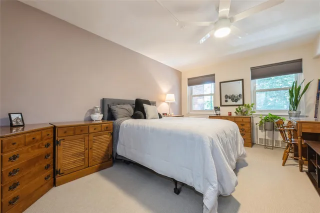 a bedroom with a bed a dresser and a book shelf