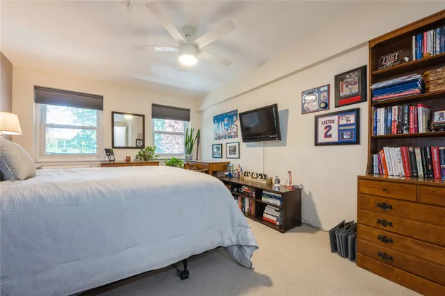 a bedroom with a bed and a lamp