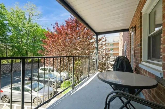 a balcony with table and chairs