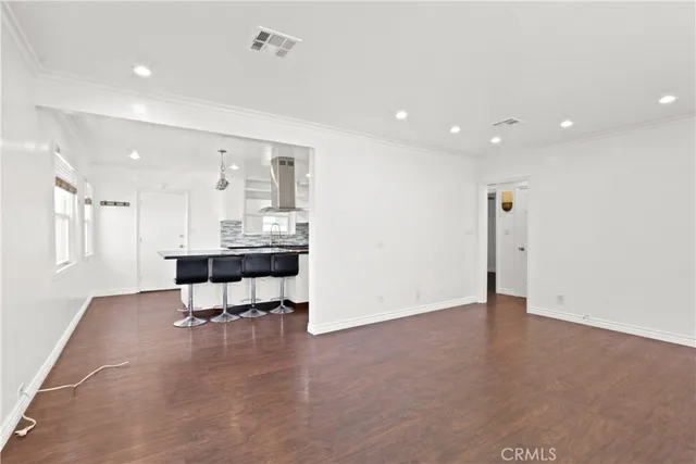 a kitchen with granite countertop a sink stove and cabinets