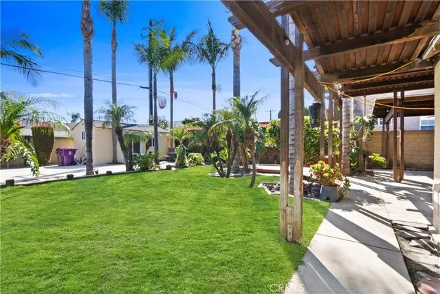 a patio with table and chairs and potted plants