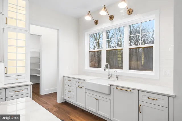 a kitchen with cabinets appliances and a window