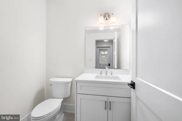 a bathroom with a sink a toilet and mirror