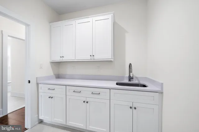 a kitchen with white cabinets