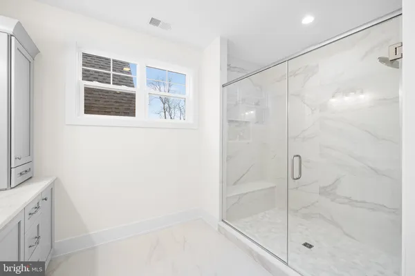 a bathroom with a bathtub and shower