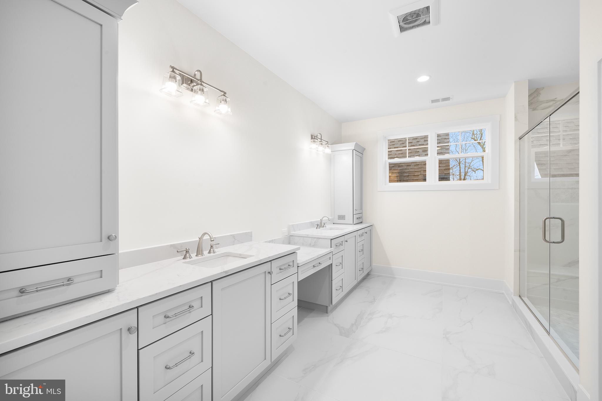 315 Old Limekiln Road Chalfont, PA 18914 - Photo 31 of 39 a spacious bathroom with a double vanity sink a mirror and a shower