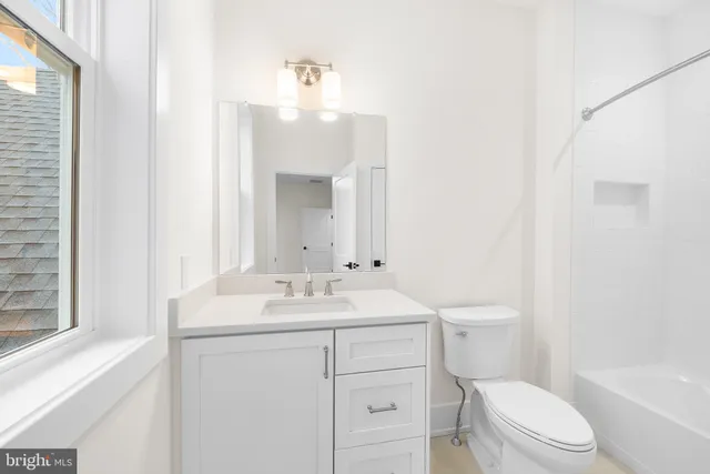 a bathroom with a sink a toilet a mirror and vanity