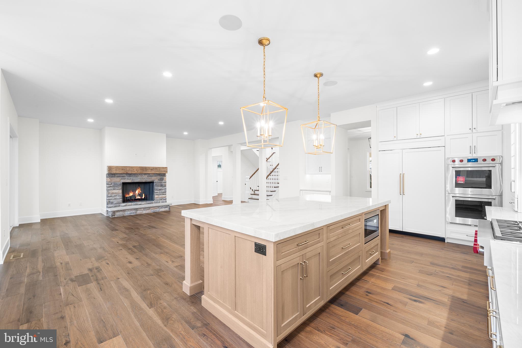 315 Old Limekiln Road Chalfont, PA 18914 - Photo 7 of 39 a large white kitchen with a large island oven a stove with wooden floors