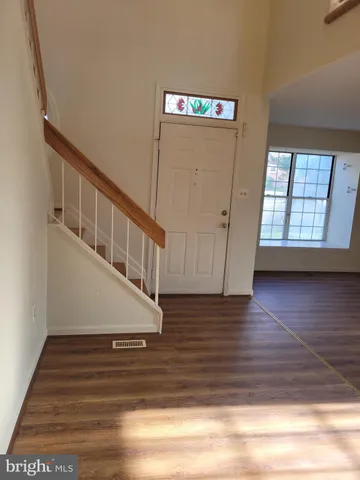 a view of an entryway with wooden floor
