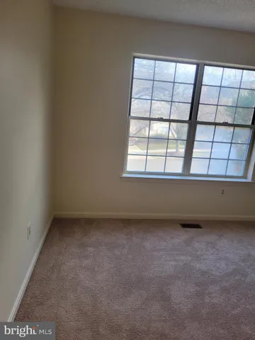 a white bath tub sitting in a bathroom next to a window