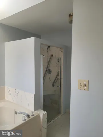 a living room with a stove and a refrigerator