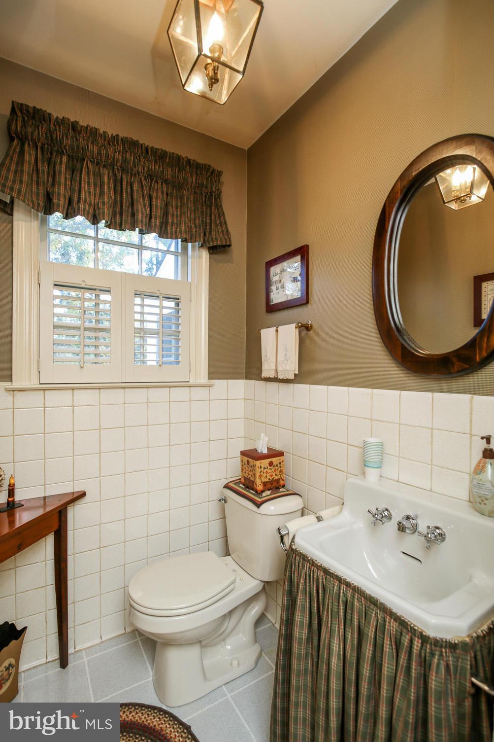 503 Worcester Road Towson, MD 21286 - Photo 10 of 18 a bathroom with a sink toilet and mirror