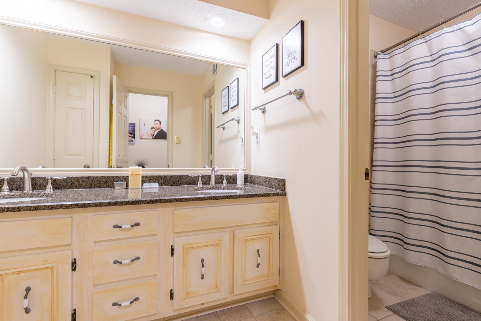 7140 River Reach Road Germantown, TN 38138 - Photo 17 of 25 a bathroom with a granite countertop sink and a mirror