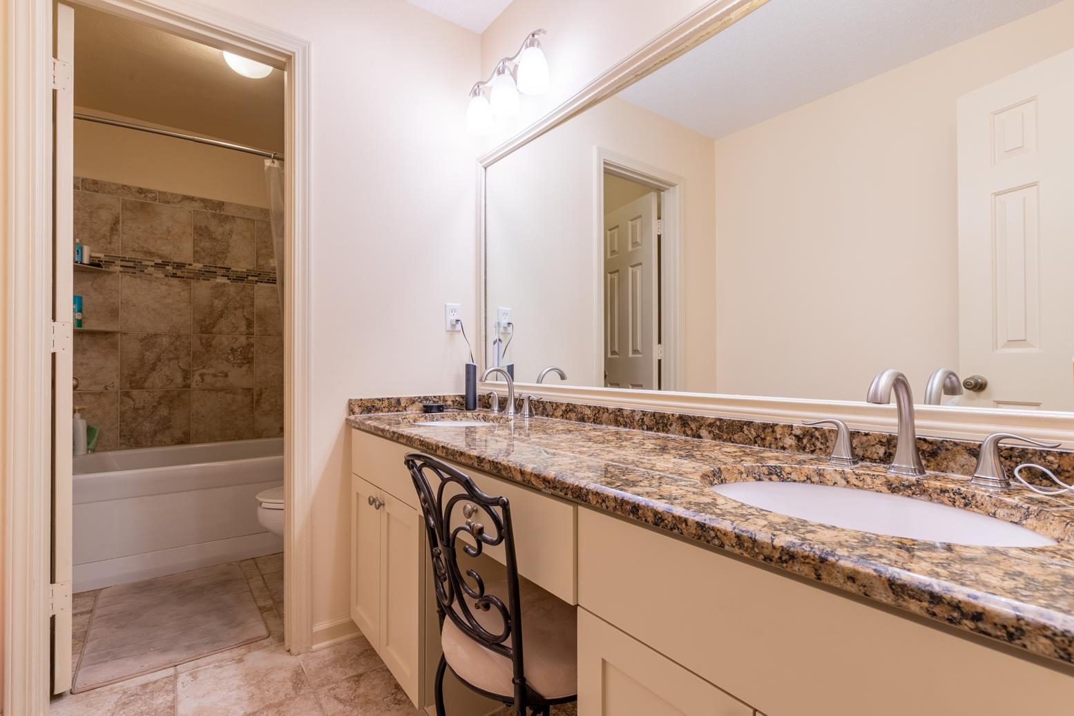 7140 River Reach Road Germantown, TN 38138 - Photo 19 of 25 a bathroom with a granite countertop sink and a mirror