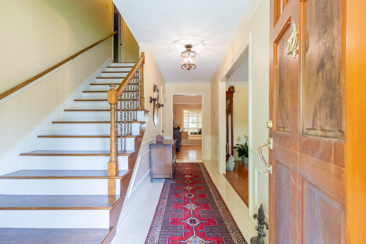 7140 River Reach Road Germantown, TN 38138 - Photo 3 of 25 a view of a hallway with wooden floor and staircase