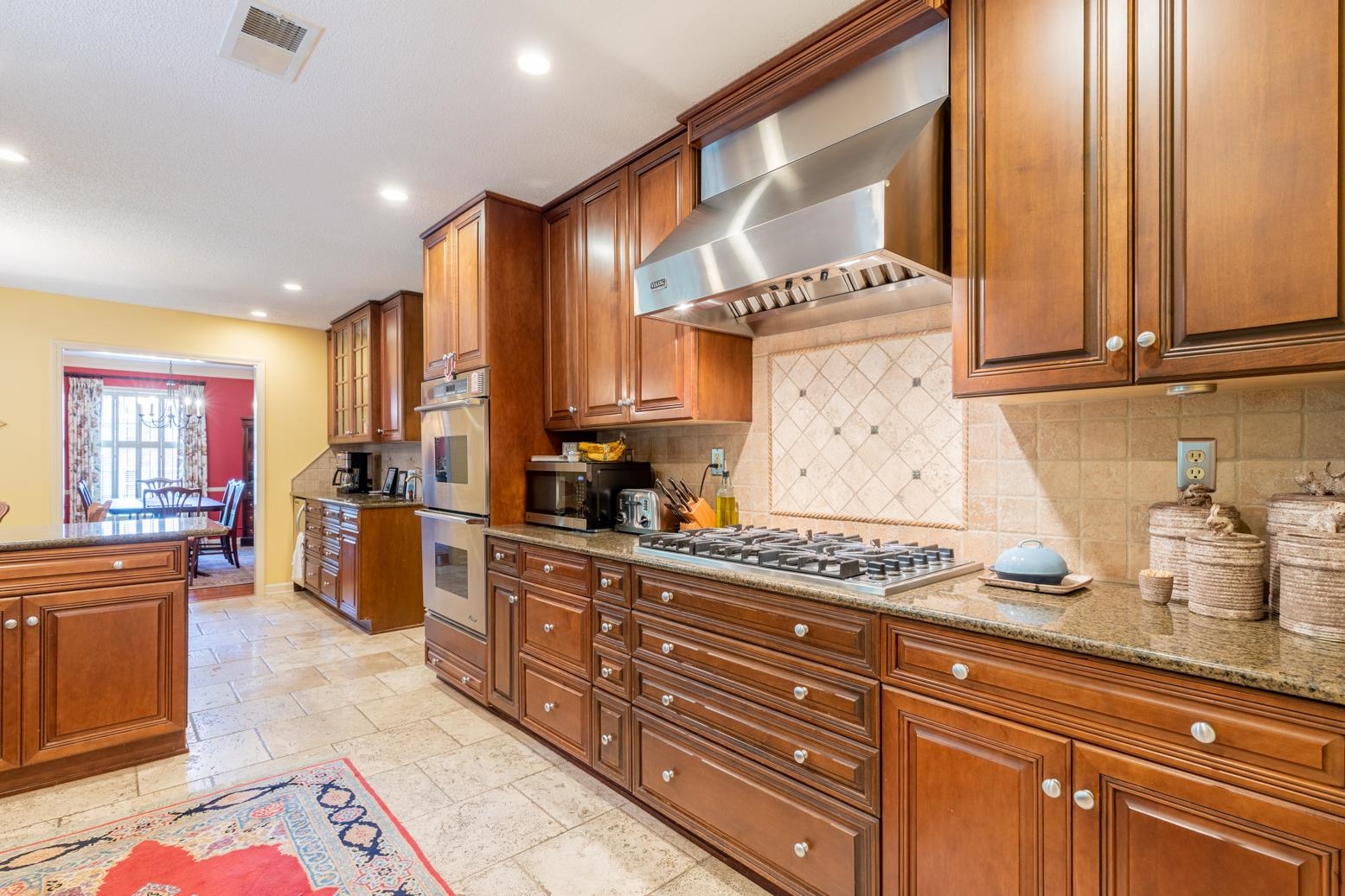7140 River Reach Road Germantown, TN 38138 - Photo 8 of 25 a kitchen with stainless steel appliances granite countertop a sink and cabinets