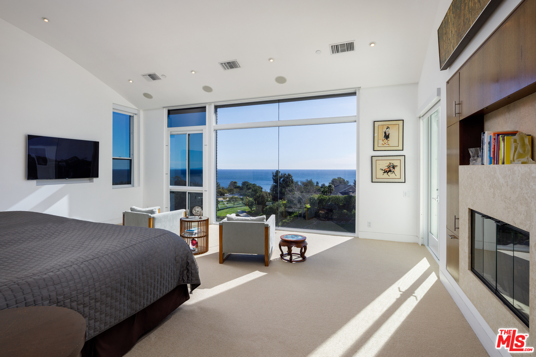 27454 Winding Way Malibu, CA 90265 - Photo 21 of 38 a living room with a flat screen tv a rug and a large window