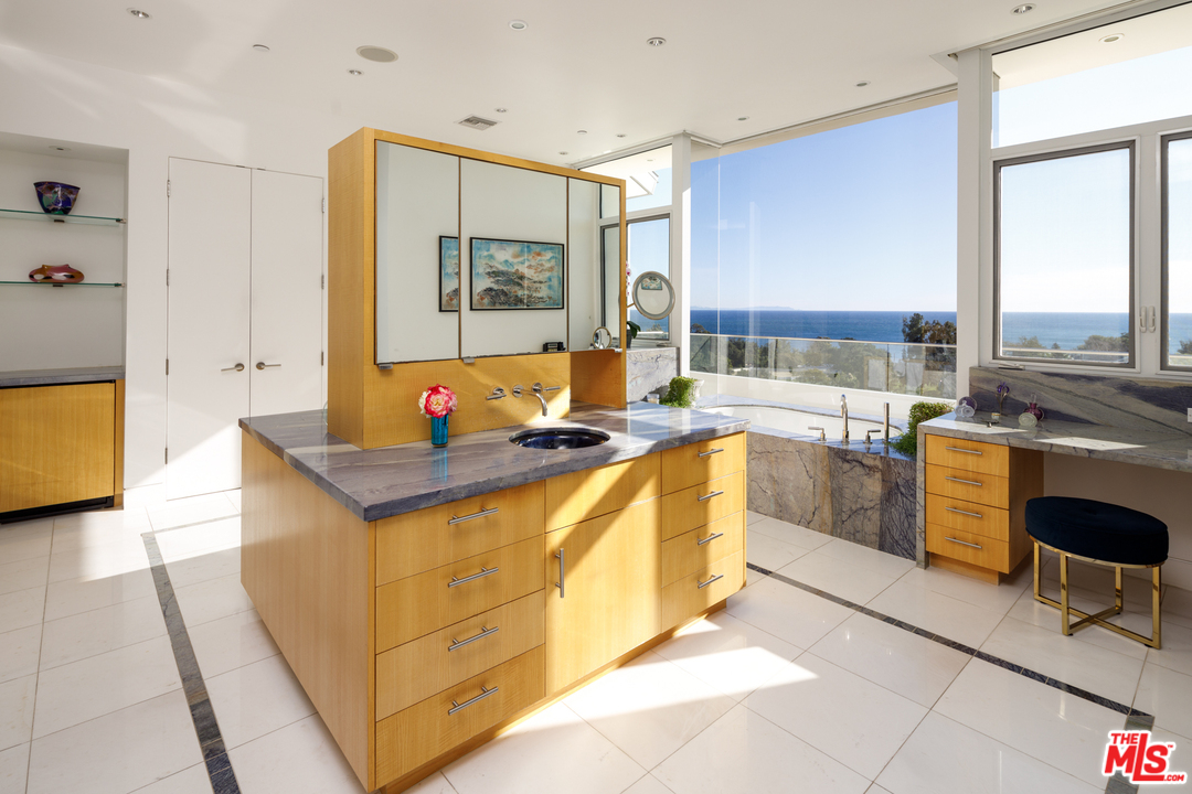27454 Winding Way Malibu, CA 90265 - Photo 22 of 38 a kitchen with stainless steel appliances granite countertop a sink and a stove