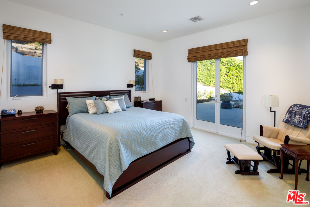 27454 Winding Way Malibu, CA 90265 - Photo 25 of 38 a bedroom with a bed and window