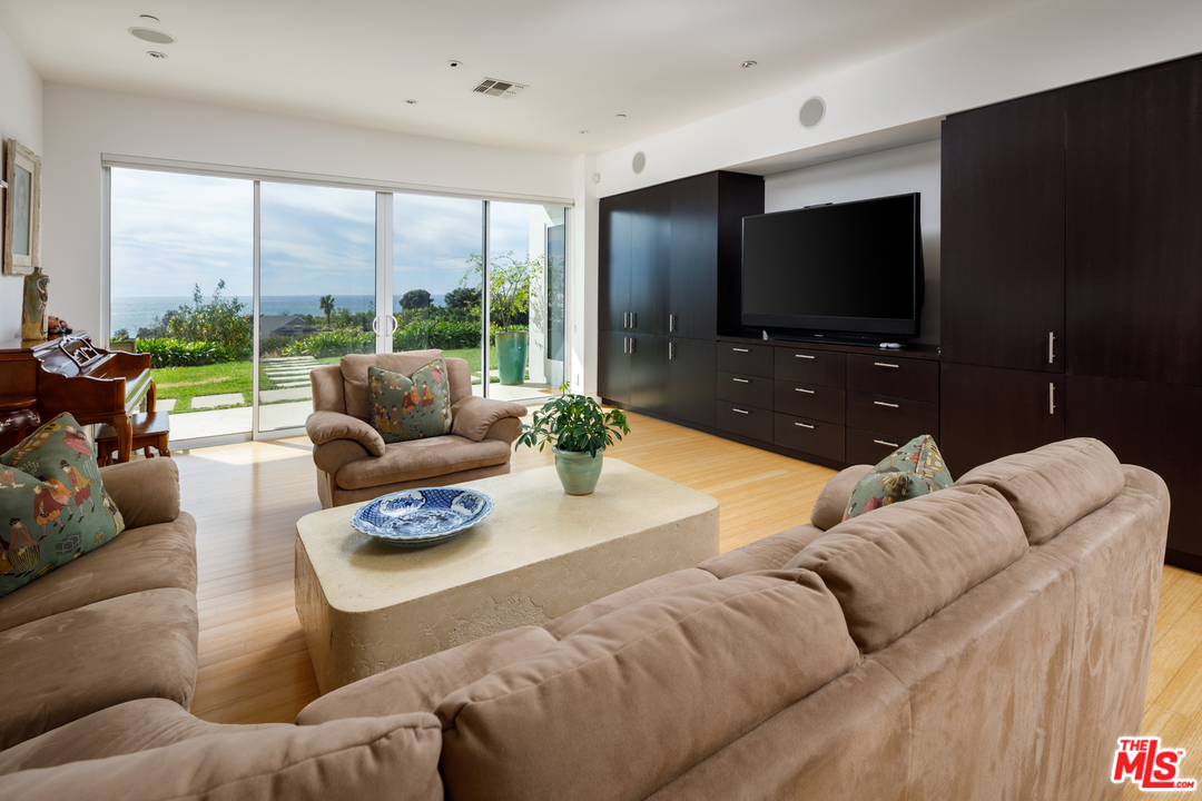 27454 Winding Way Malibu, CA 90265 - Photo 27 of 38 a living room with furniture and a flat screen tv