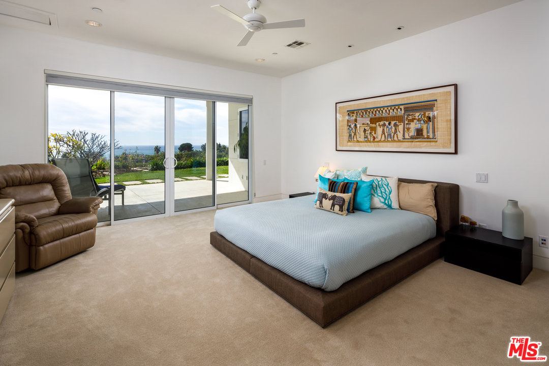 27454 Winding Way Malibu, CA 90265 - Photo 28 of 38 a spacious bedroom with a bed and a couch