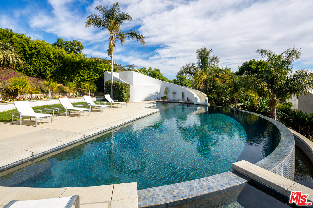27454 Winding Way Malibu, CA 90265 - Photo 32 of 38 a view of a lake with a house in the background