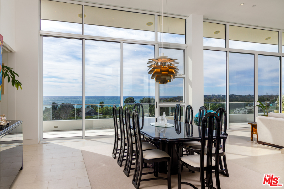 27454 Winding Way Malibu, CA 90265 - Photo 9 of 38 a dining room with furniture water view and a floor to ceiling window