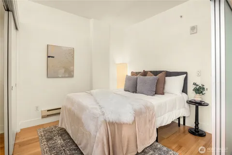 a bedroom with a bed and wooden floor