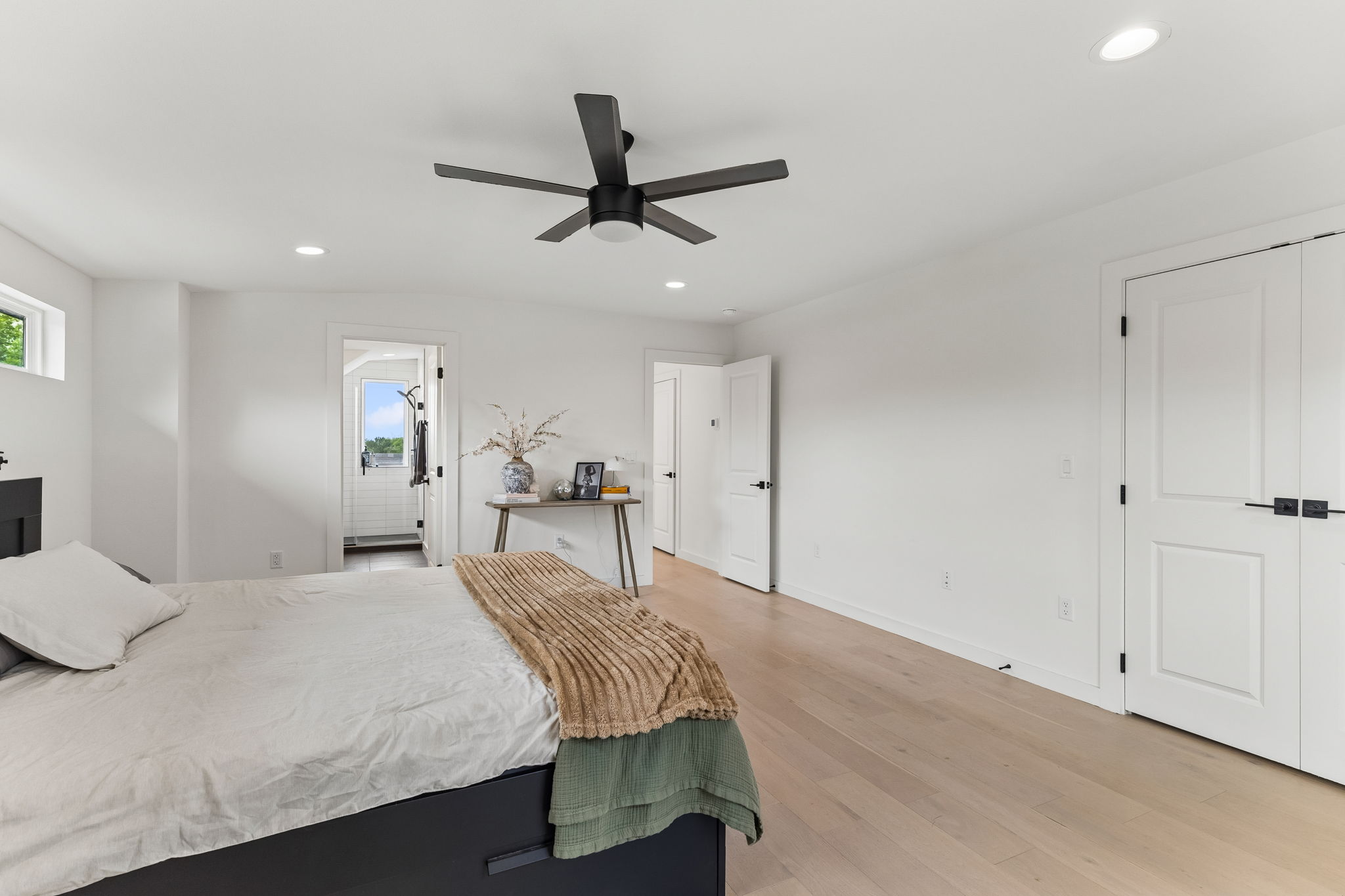 5305 Ledesma Road, Unit 1 Austin, TX 78721 - Photo 14 of 26 Another view of the primary suite, highlighting the ample wall space for a king-sized bed and the sleek, modern ceiling fan that provides both style and airflow.