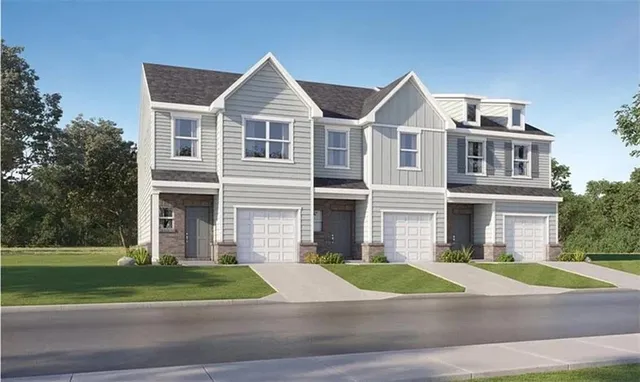 a view of a white house next to a yard