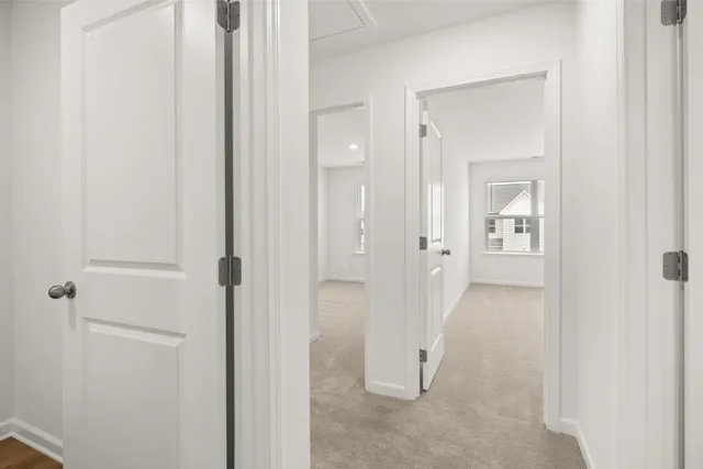 a view of a bathroom from a hallway