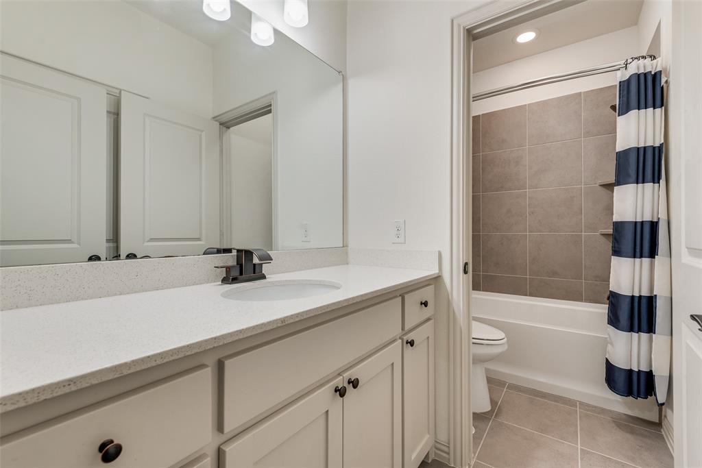 2021 Calisto Way Allen, TX 75013 - Photo 28 of 34 Bathroom vanity featuring a light-colored countertop, undermount sink, and matte black faucet