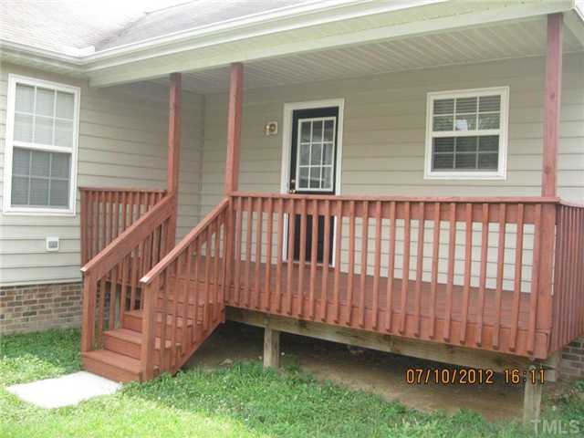 4321 Moss Spring Drive Raleigh, NC 27616 - Photo 4 of 7 a view of a house with a yard and deck
