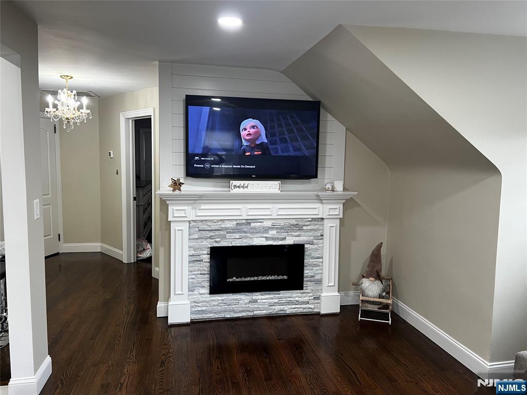 60 Dick Street Clifton, NJ 07013 - Photo 4 of 10 a living room with furniture a fireplace and a flat screen tv